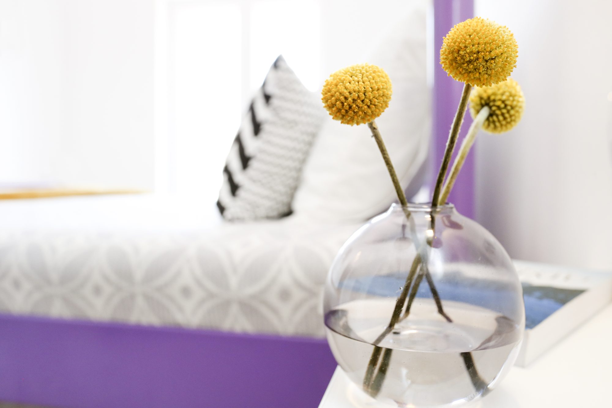 Vase with yellow flowers on a bedside table in the villa near Sibenik